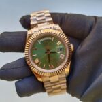 rolex-day-date-40mm-president-rose-gold-fluted-bezel-green-roman-dial-mens-watch-replica-syqgc.webp