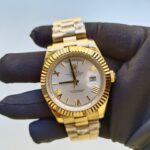 rolex-day-date-40mm-yellow-gold-silver-roman-dial-fluted-bezel-president-bracelet-228238-replica-tjvny.webp
