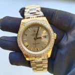 rolex-day-date-ii-yellow-gold-champagne-diamond-41mm-roman-dial-diamond-bezel-president-bracelet-watch-replica-1d6yp.webp